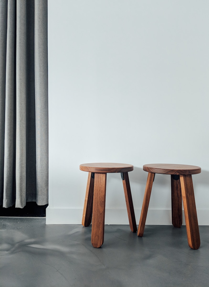two brown wooden stools