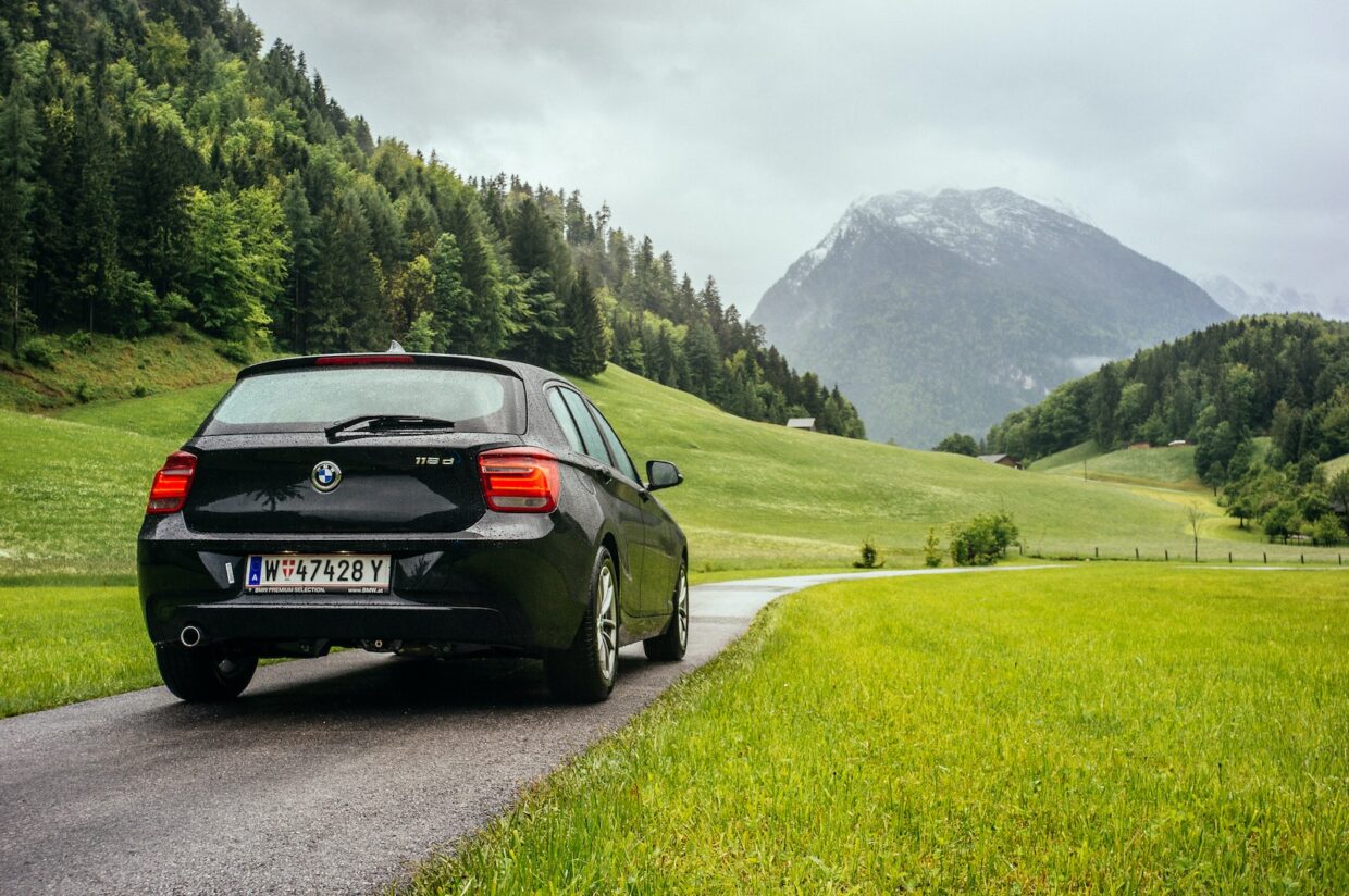 Black BMW on a Road in Mountains